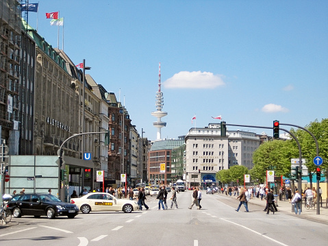 Hamburg, Germany - May 22, 2008: View of famous street Jungfernstieg towards tv tower Heinrich-Hertz-Turm. Shopping mall Alsterhaus on the left.