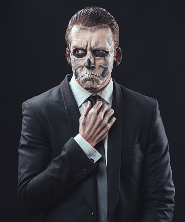 pensive businessman with make-up skeleton