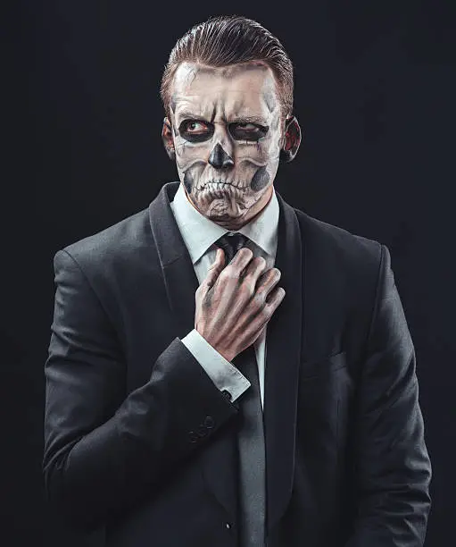 Photo of pensive businessman with makeup skeleton