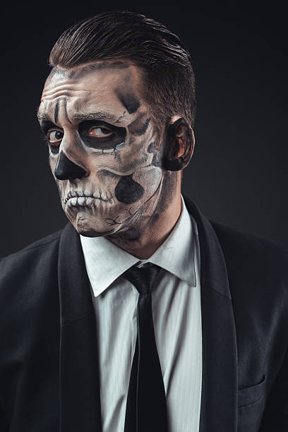 istock incredulous businessman with makeup skeleton 540366466