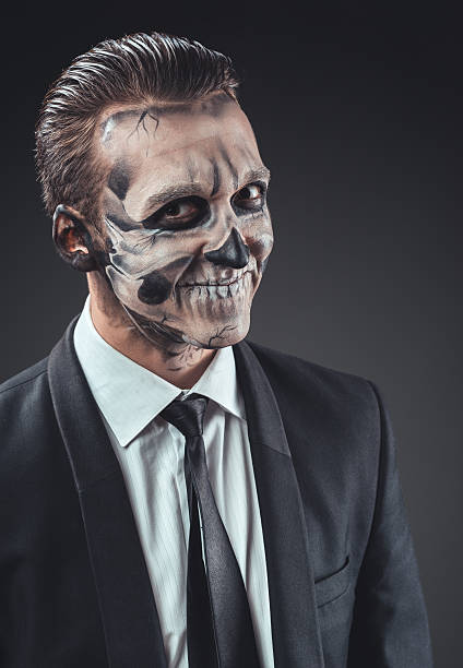 istock cunning businessman with a makeup of the skeleton 540366566