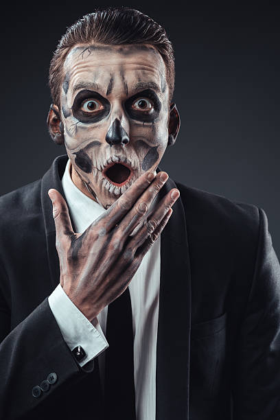 istock Surprised businessman with a makeup  skeleton 540366832