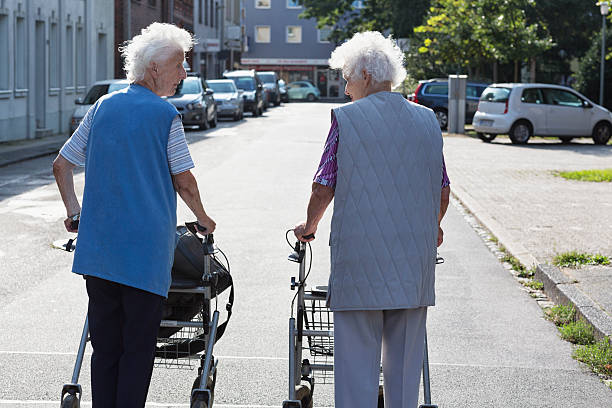 istock senior women together walking with walker 540366894