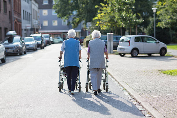 istock senior women together walking with walker 540367194