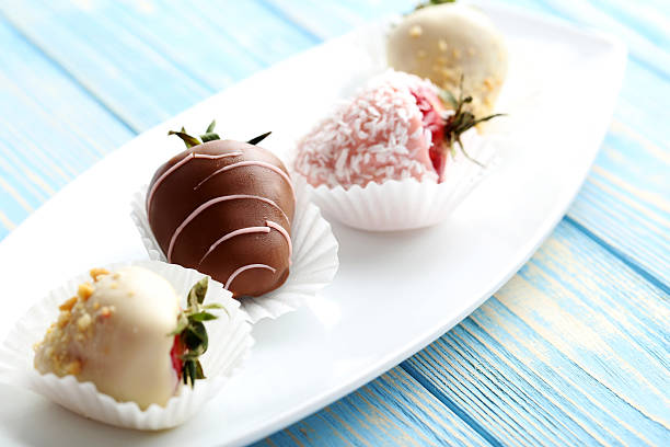 istock Strawberries covered in chocolate on a blue wooden table 540367332