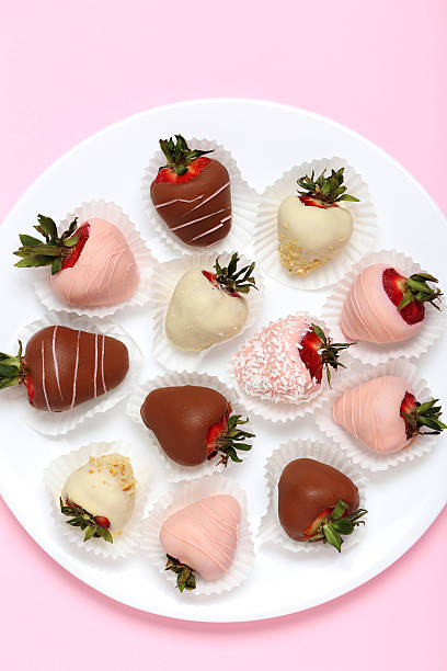 istock Strawberries covered in chocolate on a pink background 540367430