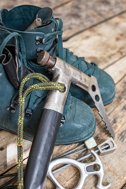 istock Handmade ice axe with old boots on wood background 540368294