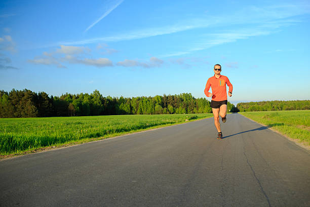 istock Man running on country road, training inspiration and motivation 540369716