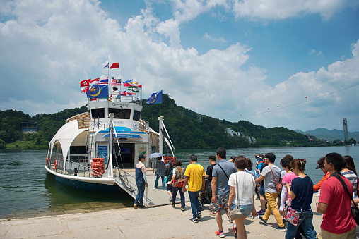 Chuncheon, South Korea - June 13, 2016: Chuncheon, South Korea - june 16, 2016: Ferry with full of tourists Leaving the pier of Nami or Namiseom island, the resort island in Chuncheon city to South Korea on june 16, 2016 in Chuncheon