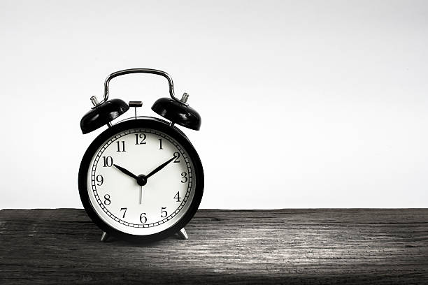 istock Alarm clock on wood isolated on white background. 540370774