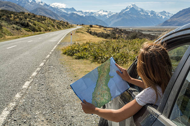istock Car passenger looks at map for directions 540371582