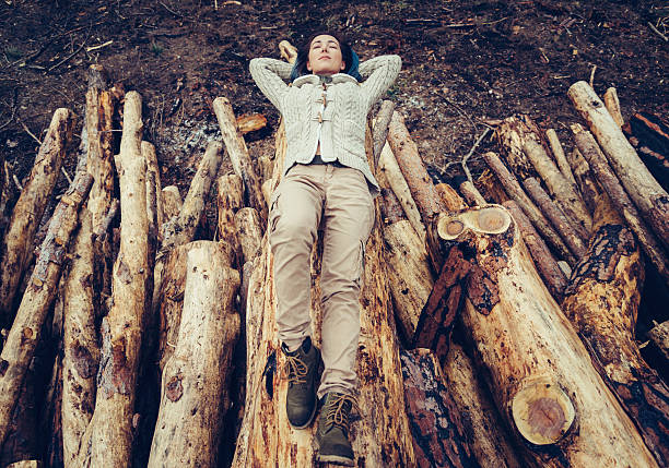 istock Woman lying on felled tree trunk 540372024