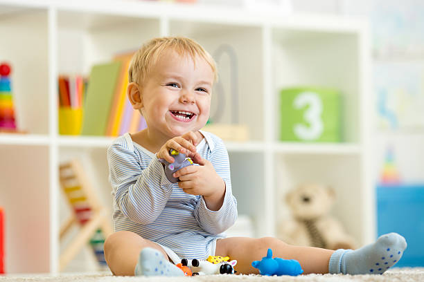 istock little child plays with toys animals 540372526