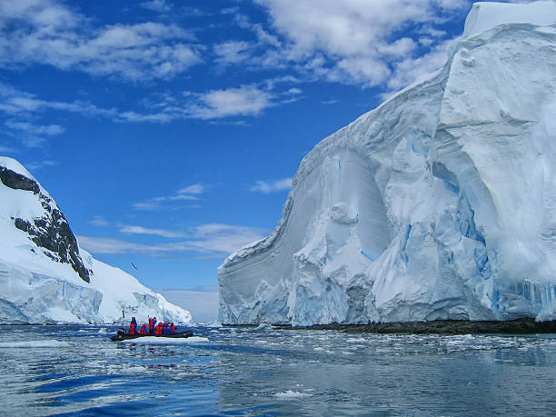 istock Cruise passengers studying a large iceberg in Antarctica 540373440