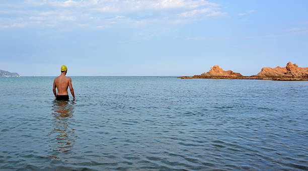 swimmer training on the beach stock photo