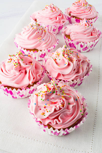 istock Pink cupcakes on the linen napkin 540376226