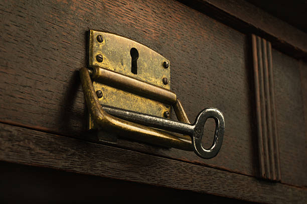 istock Old rusty lock in a wooden drawer with a key 540377378