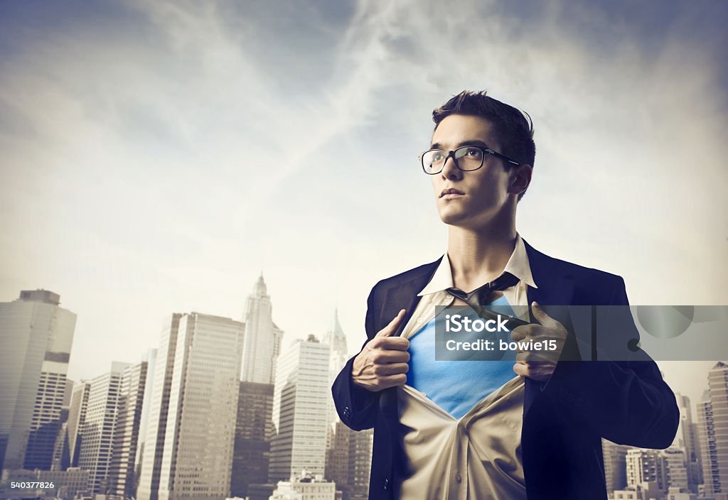 Businessman ripping shirt open in city Smart young businessman with glasses ripping his shirt open in the city  Men Stock Photo