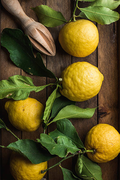 istock Fresh lemons with leaves in rustic wooden box 540378062