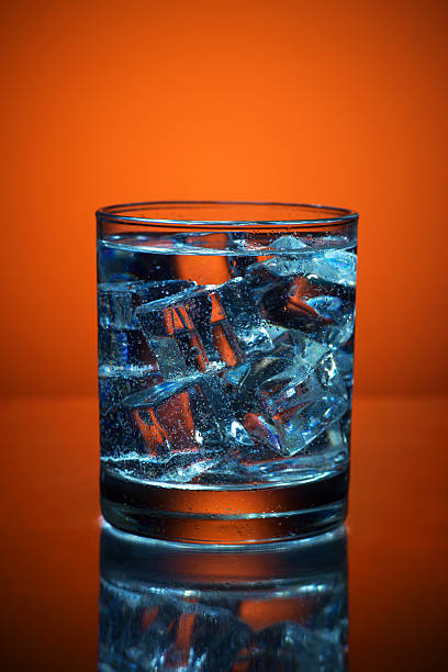 istock Close up of cold water glass with ice cubes. 540378420