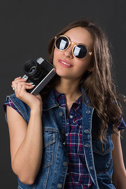 istock attractive young girl with a camera 540381018
