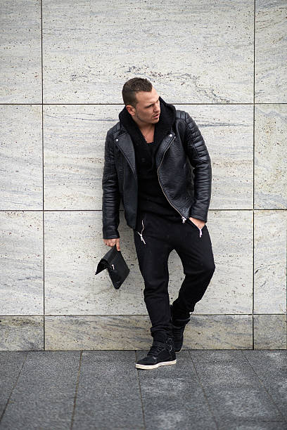 istock trendy guy standing near  wall 540382134