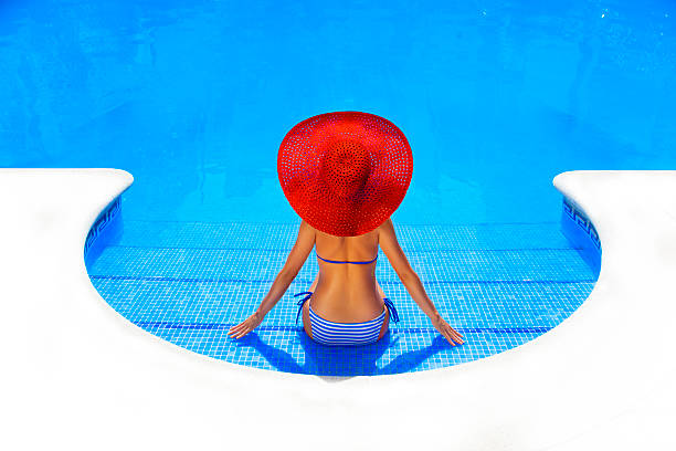 woman relaxing in resort swimming pool
