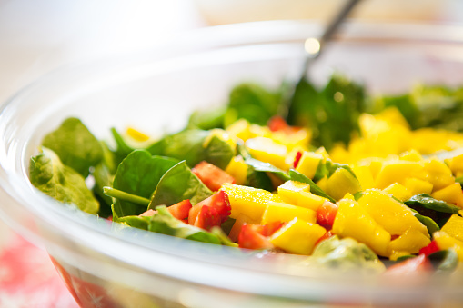 Spinach salad with mango and strawberries.