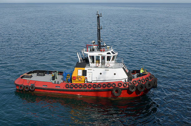 istock Red tug boat on  water 540391986