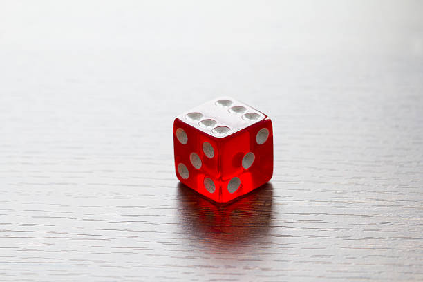 istock Red dice isolated on wooden desktop 540392322