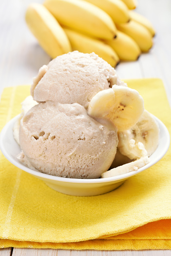 Banana ice cream decorated with slices in bowl