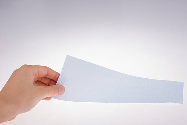istock Piece of black paper in hand 540395384