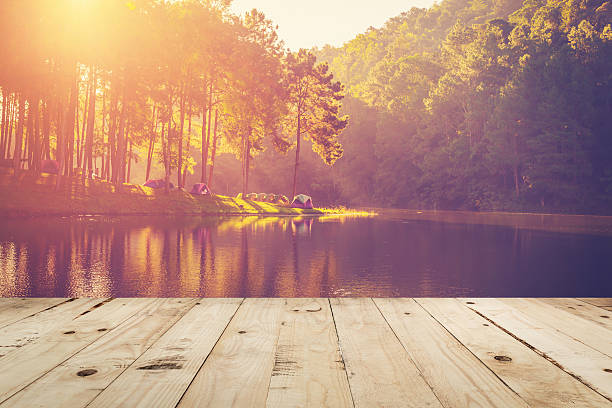 istock Wood table and Pond water and sunrise with vintage effect. 540395624