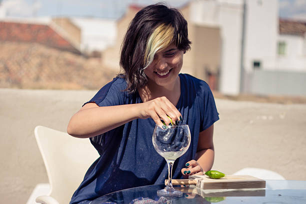 istock Beautiful girl squeezing lemon in a glass 540397344