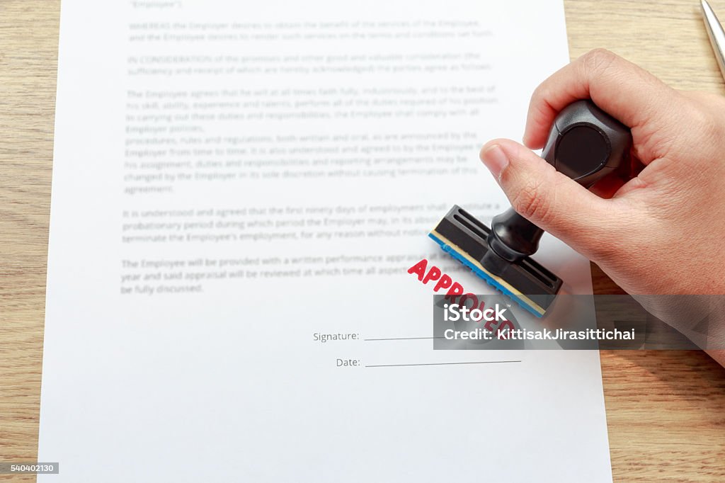 Approved the contract documents with rubber stamp Approved the contract documents with rubber stamp concept Endorsing Stock Photo