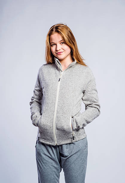Girl gray hooded sweatshirt, young woman, studio shot Teenage girl in jeans and gray tank top, young woman, studio shot on gray background tracksuit stock pictures, royalty-free photos & images