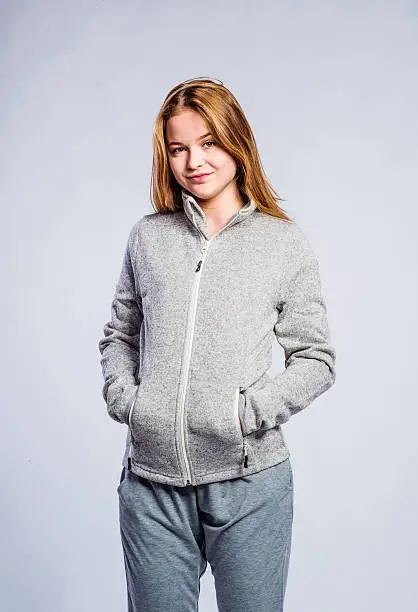 Photo of Girl gray hooded sweatshirt, young woman, studio shot