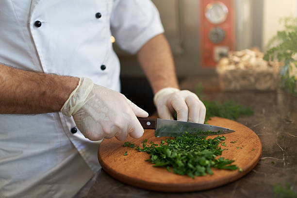 istock Cook chops fresh herbs on  wooden board 540403544