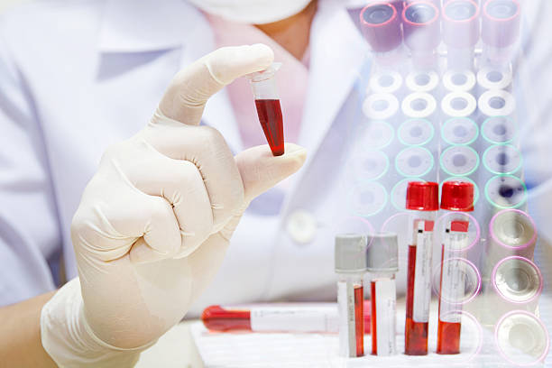 istock young female scientist holding tube with blood sample 540404128