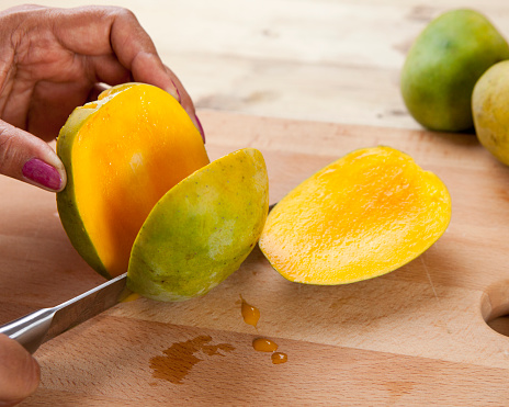Cutting mangoes.