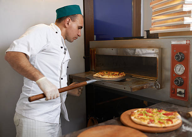 istock Cook took the pizza from  oven ready 540405094