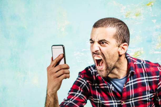 A young guy, shouting at someone in his smartphone. Image taken with Canon EOS 5 Ds Mark  and EF 70-200 mm USM L. Istockalypse Paris 2016.