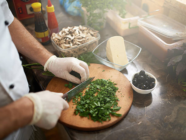 istock Chef cuts the parsley on  board for pizza 540405970