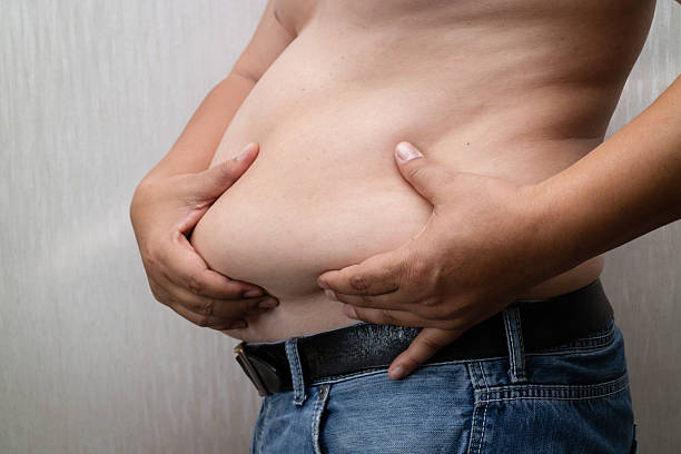 istock Fat man checking out his weight. 540406310