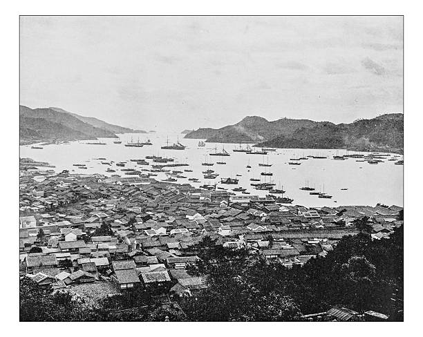 Antique photograph of city and harbor of Nagasaki (Japan-19th century) Antique photograph of view of city and harbor of Nagasaki (Japan) as the settlement on the island of Kyushu appeared during the 19th century, when there were still parts of the ancient city destroyed following the atomic bombing. nagasaki prefecture photos stock illustrations