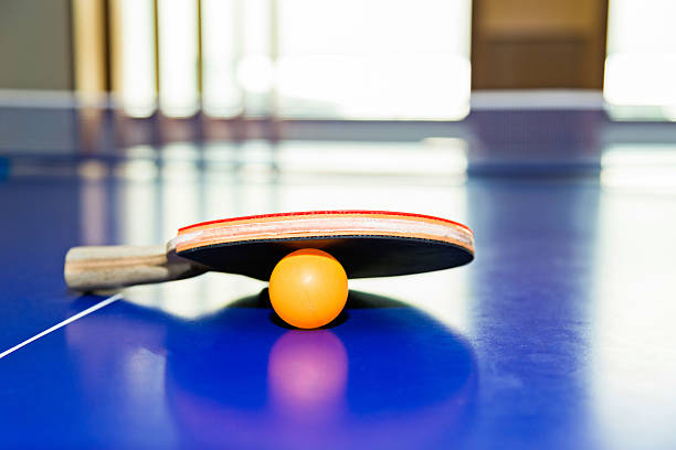 istock Ping-Pong paddles with ball on table 540408588