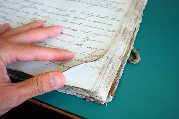 istock man showing very old book pages 540487492
