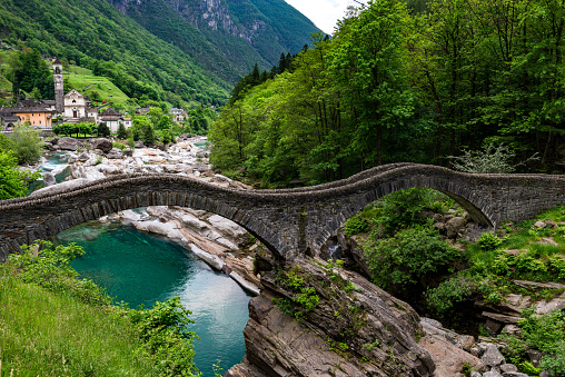valley verzasca in Switzerland with old stone bridge and church