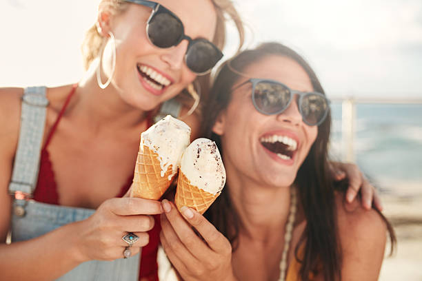 istock Female friends having fun and eating ice cream 540488002