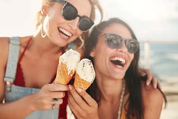 Photo of Female friends having fun and eating ice cream